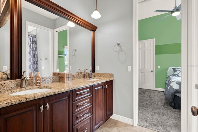 13112 Luntz Point Ln, Windermere, FL 34786 - full bathroom featuring connected bathroom, double vanity, a ceiling fan, tile patterned flooring, and baseboards
