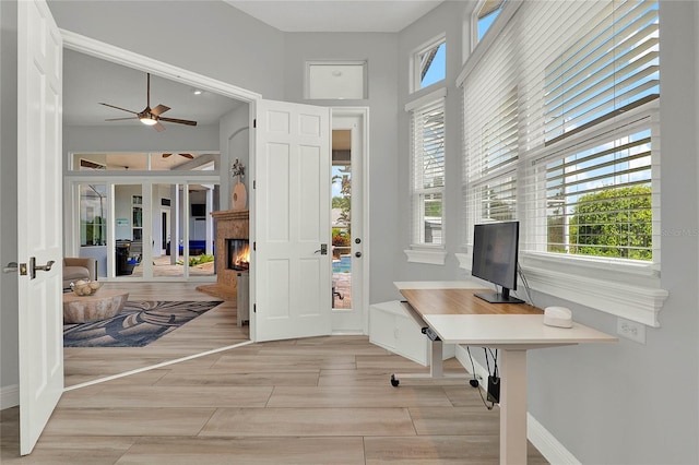 13112 Luntz Point Ln, Windermere, FL 34786 - office area featuring healthy amount of natural light, a ceiling fan, french doors, a glass covered fireplace, and a high ceiling