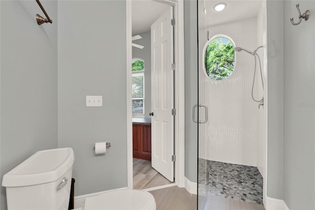 13112 Luntz Point Ln, Windermere, FL 34786 - bathroom with toilet, a shower stall, and baseboards