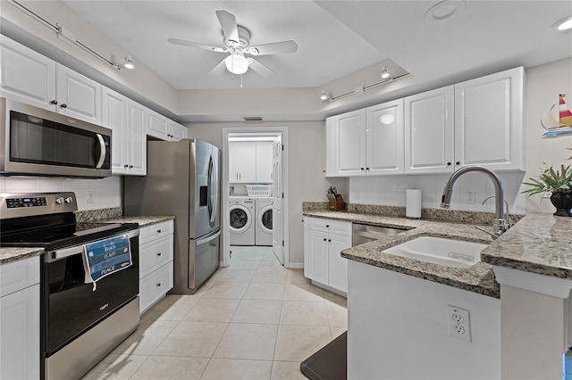 5300 S Atlantic Ave Unit 16-202, New Smyrna Beach, FL 32169 - kitchen featuring appliances with stainless steel finishes, ceiling fan, a sink, washing machine and dryer, and a peninsula