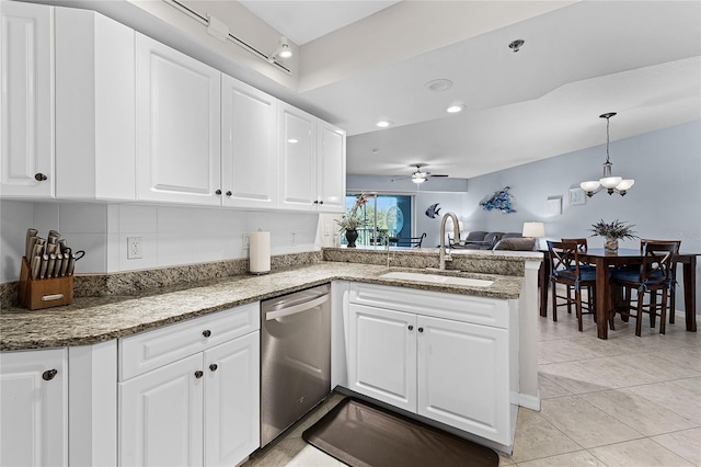 5300 S Atlantic Ave Unit 16-202, New Smyrna Beach, FL 32169 - kitchen featuring white cabinets, a sink, dishwasher, a peninsula, and ceiling fan with notable chandelier