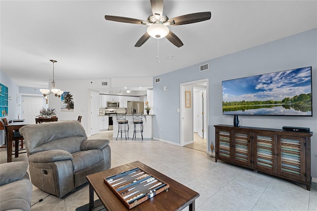 5300 S Atlantic Ave Unit 16-202, New Smyrna Beach, FL 32169 - living room featuring baseboards, visible vents, light tile patterned floors, and ceiling fan with notable chandelier