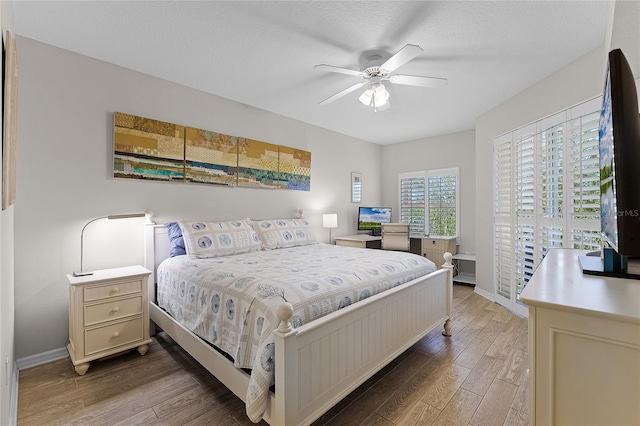 5300 S Atlantic Ave Unit 16-202, New Smyrna Beach, FL 32169 - bedroom with wood finished floors, ceiling fan, and baseboards