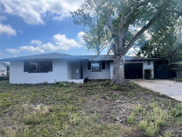 10228 Amadeus Dr, Port Richey, FL 34668 - ranch-style home featuring central AC unit, concrete driveway, stucco siding, and an attached garage