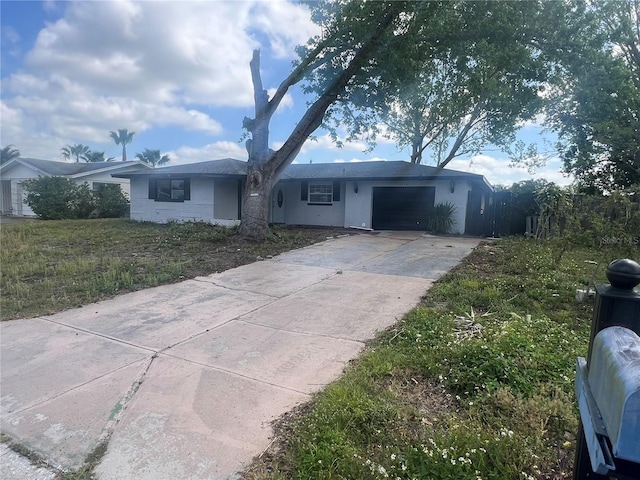 10228 Amadeus Dr, Port Richey, FL 34668 - ranch-style house with stucco siding, driveway, and a garage