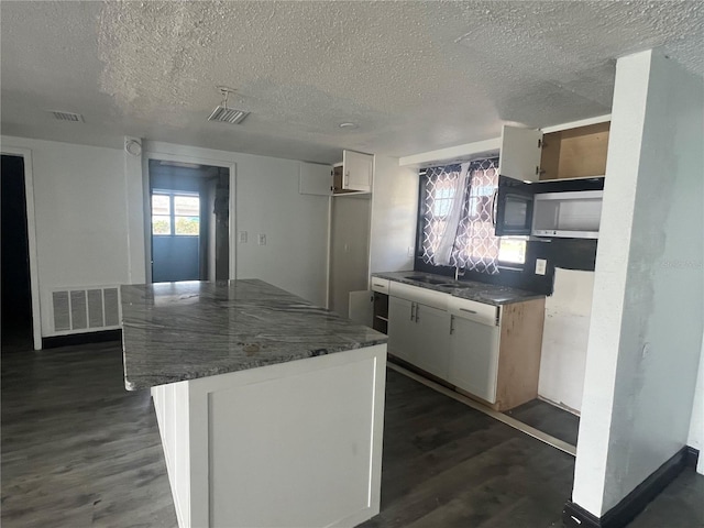 10228 Amadeus Dr, Port Richey, FL 34668 - kitchen with a sink, dark wood-style flooring, and visible vents