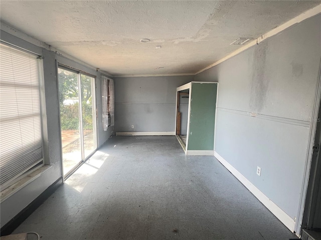 10228 Amadeus Dr, Port Richey, FL 34668 - spare room featuring baseboards, a textured ceiling, visible vents, and tile patterned floors