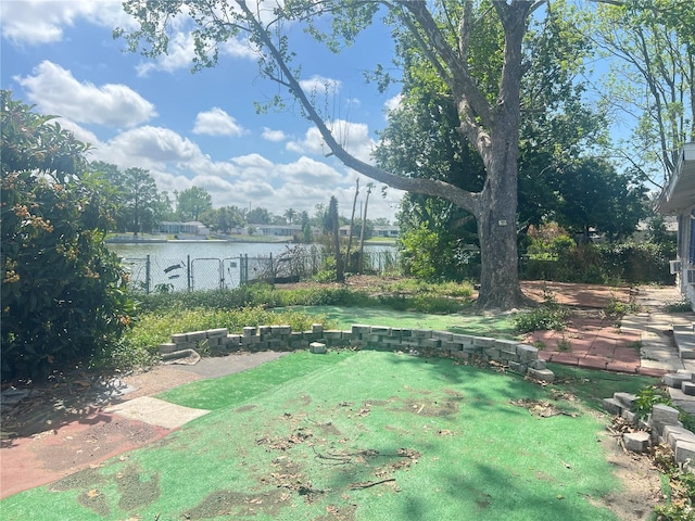 10228 Amadeus Dr, Port Richey, FL 34668 - view of yard featuring a water view and fence