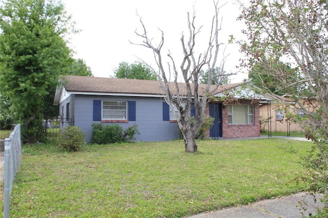 5177 Edwina St, Orlando, FL 32811 - ranch-style home with a front lawn, concrete block siding, and fence