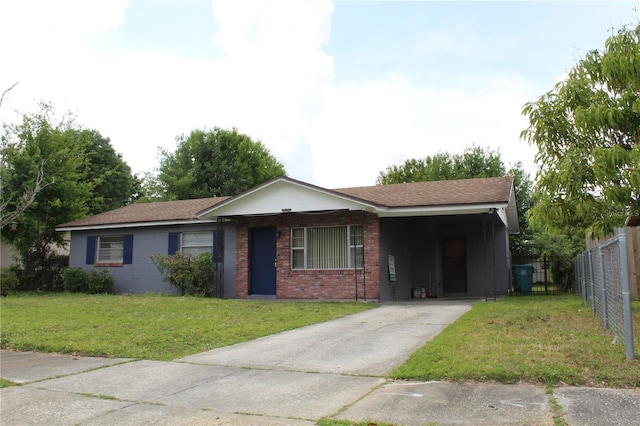 5177 Edwina St, Orlando, FL 32811 - ranch-style house with concrete driveway, an attached carport, fence, brick siding, and a front lawn