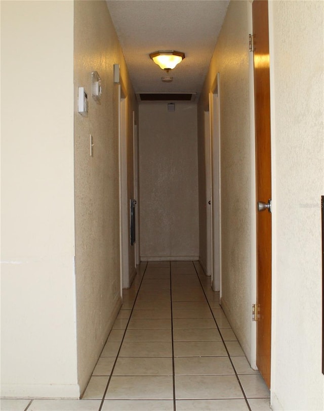 5177 Edwina St, Orlando, FL 32811 - hallway with light tile patterned floors and a textured wall