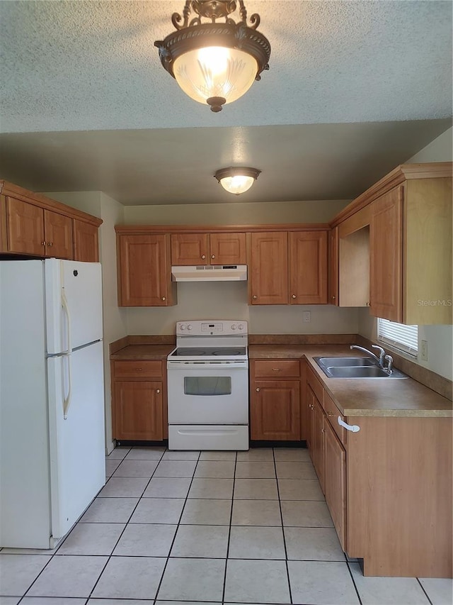 5177 Edwina St, Orlando, FL 32811 - kitchen with light tile patterned flooring, a textured ceiling, white appliances, under cabinet range hood, and a sink