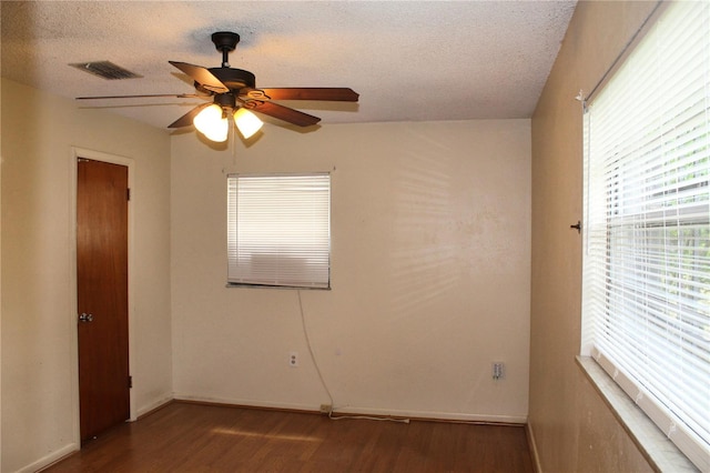 5177 Edwina St, Orlando, FL 32811 - empty room with wood finished floors, a textured ceiling, ceiling fan, and visible vents