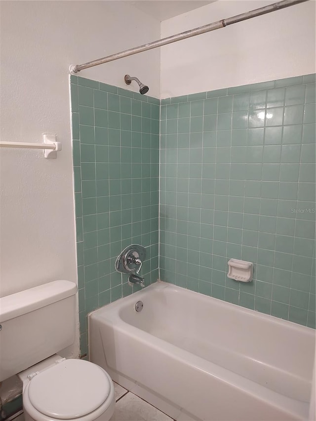 5177 Edwina St, Orlando, FL 32811 - bathroom with toilet, tile patterned flooring, and bathing tub / shower combination