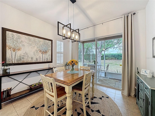 dining space with light tile patterned floors and a notable chandelier