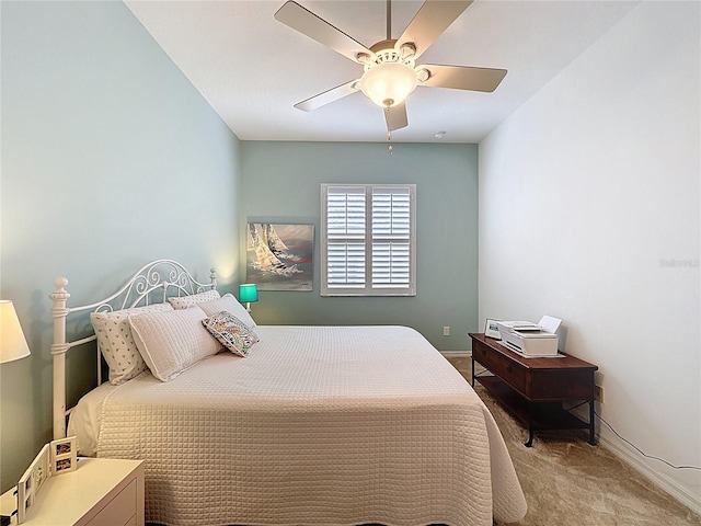 bedroom featuring baseboards, ceiling fan, and light carpet