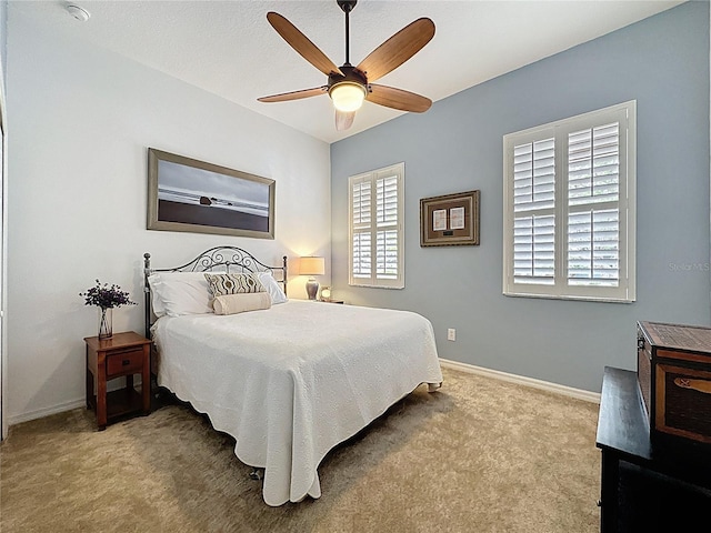 bedroom with baseboards, ceiling fan, and carpet