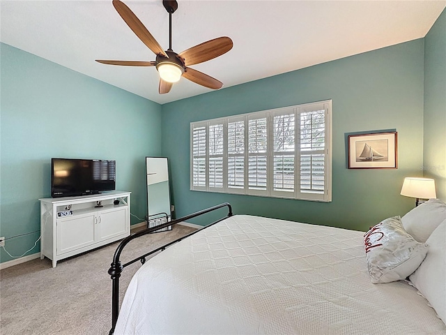 bedroom featuring baseboards, carpet floors, and a ceiling fan