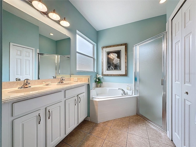 bathroom featuring double vanity, a sink, a garden tub, and a stall shower