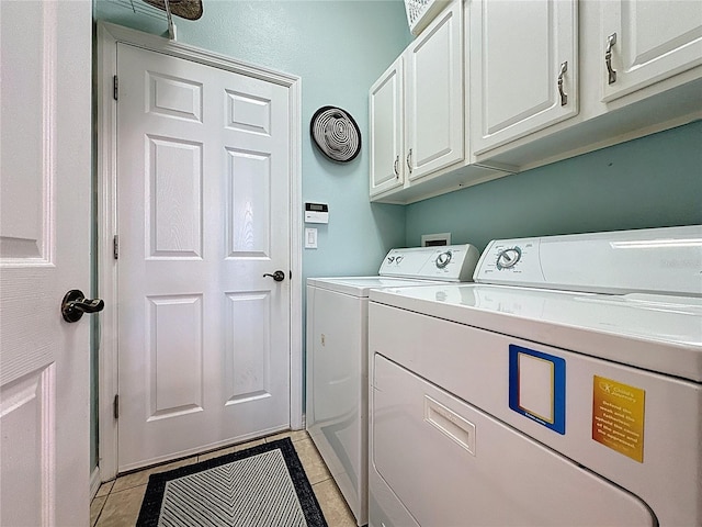clothes washing area with light tile patterned flooring, independent washer and dryer, visible vents, and cabinet space