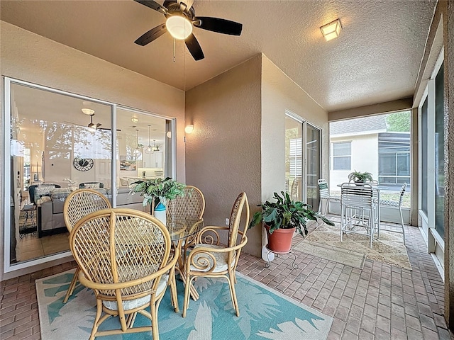 sunroom / solarium featuring ceiling fan