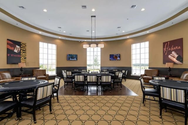 dining room with a wainscoted wall, a wealth of natural light, and visible vents