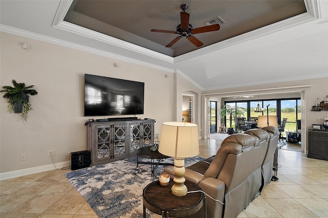 living area featuring visible vents, crown molding, a ceiling fan, arched walkways, and a tray ceiling