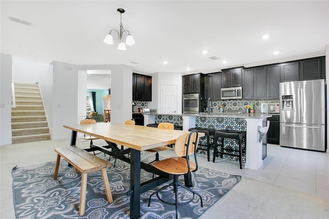 161 Williamson Dr, Davenport, FL 33897 - dining room featuring a chandelier, stairs, visible vents, and recessed lighting