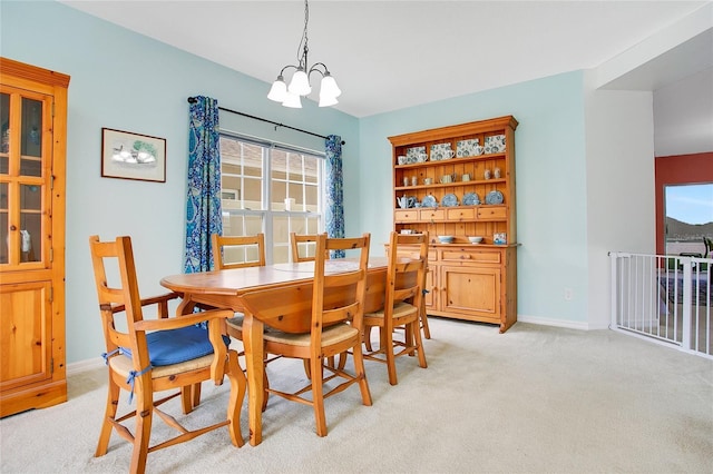 161 Williamson Dr, Davenport, FL 33897 - dining area with baseboards, a notable chandelier, and light carpet
