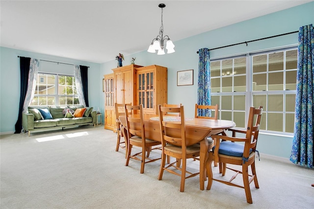 161 Williamson Dr, Davenport, FL 33897 - dining area featuring baseboards, a notable chandelier, and light colored carpet