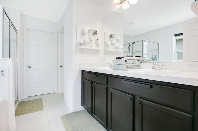 161 Williamson Dr, Davenport, FL 33897 - bathroom featuring a stall shower, tile patterned floors, double vanity, and a sink