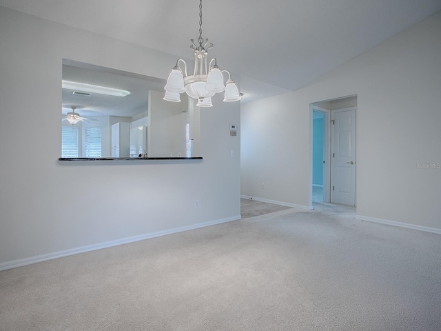 unfurnished room featuring light carpet, baseboards, lofted ceiling, and ceiling fan with notable chandelier