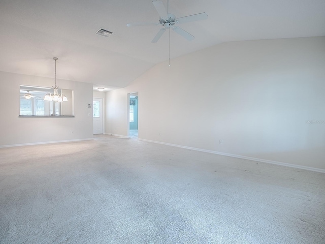 empty room with ceiling fan with notable chandelier, lofted ceiling, light colored carpet, and visible vents