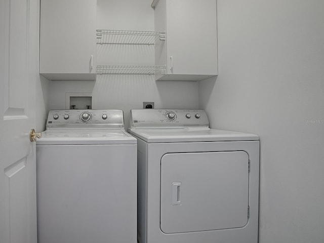 laundry room featuring cabinet space and washing machine and dryer