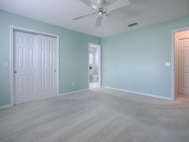 unfurnished bedroom featuring a closet, baseboards, visible vents, and carpet