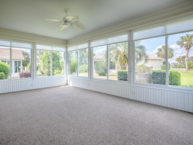 unfurnished sunroom with ceiling fan