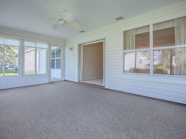 unfurnished sunroom featuring ceiling fan and visible vents