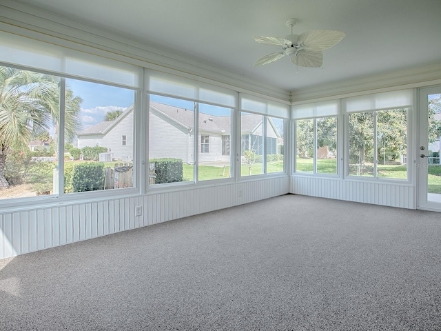 unfurnished sunroom with ceiling fan