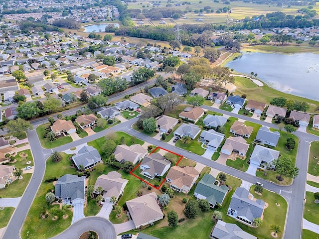 drone / aerial view with a residential view and a water view