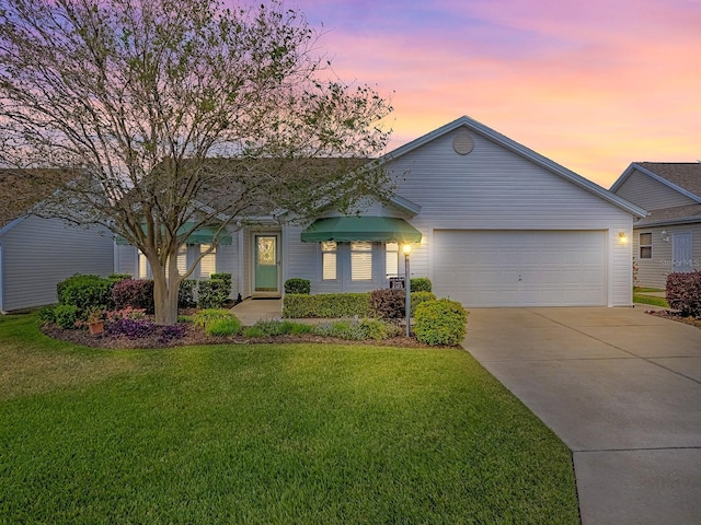 ranch-style home with a front lawn, driveway, and a garage