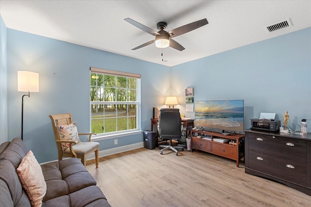 office with a ceiling fan, baseboards, light wood-style floors, and visible vents
