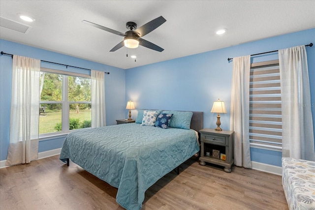 bedroom featuring visible vents, baseboards, ceiling fan, wood finished floors, and recessed lighting