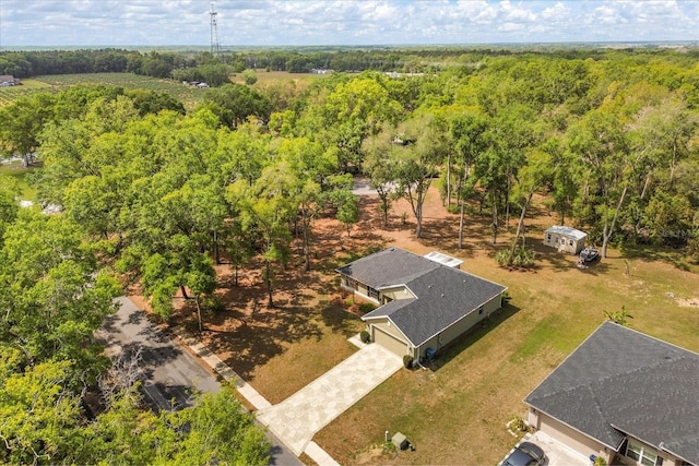 birds eye view of property with a forest view