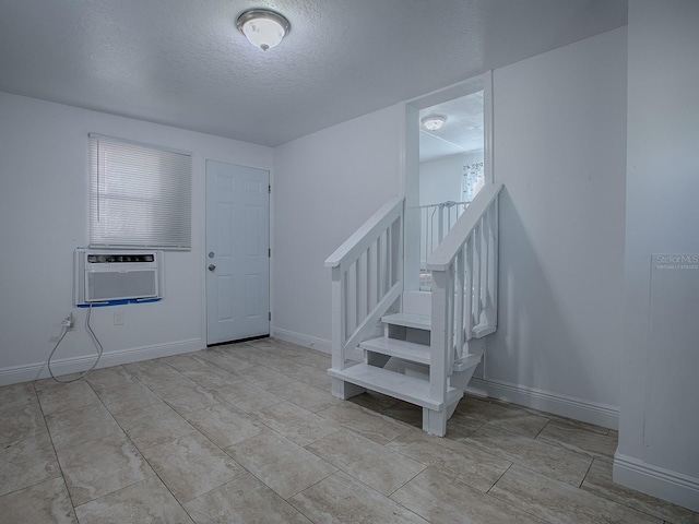 8901 SE 144th Ln, Summerfield, FL 34491 - foyer entrance featuring cooling unit, baseboards, a textured ceiling, and stairs