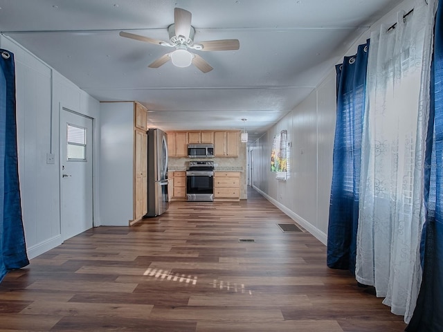 8901 SE 144th Ln, Summerfield, FL 34491 - kitchen with light brown cabinets, a wealth of natural light, appliances with stainless steel finishes, and dark wood-style flooring