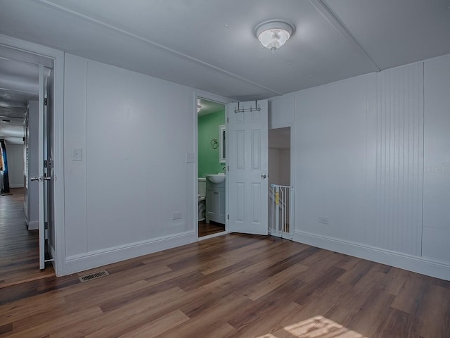 8901 SE 144th Ln, Summerfield, FL 34491 - empty room featuring visible vents, baseboards, wood finished floors, and a sink