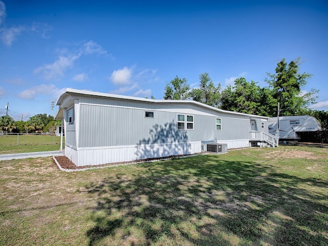 8901 SE 144th Ln, Summerfield, FL 34491 - rear view of property featuring a yard and central air condition unit