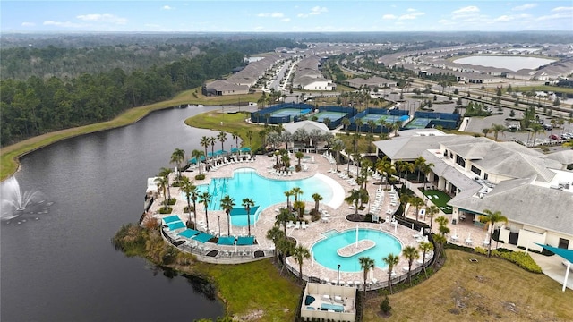 aerial view with a water view and a wooded view