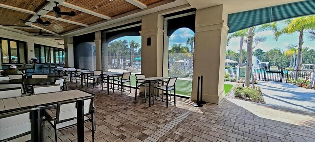 view of patio / terrace with fence, ceiling fan, and outdoor dining space