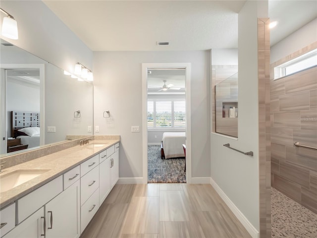 ensuite bathroom with a ceiling fan, ensuite bath, a sink, and double vanity